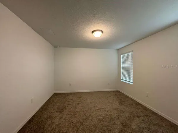 an empty room with a empty space and windows