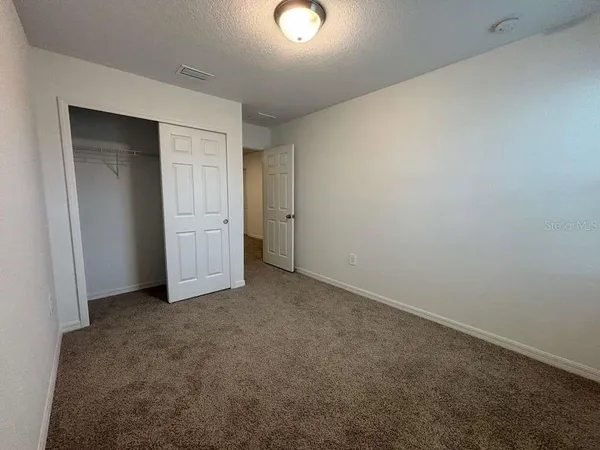 an empty room with closet area