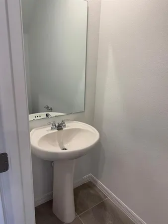 a bathroom with a sink and mirror