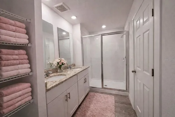 a bathroom with a double vanity sink and a mirror