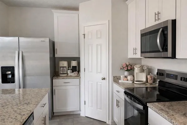 a kitchen with a sink stove and refrigerator