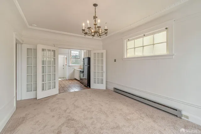 a view of a hallway with chandelier and entryway