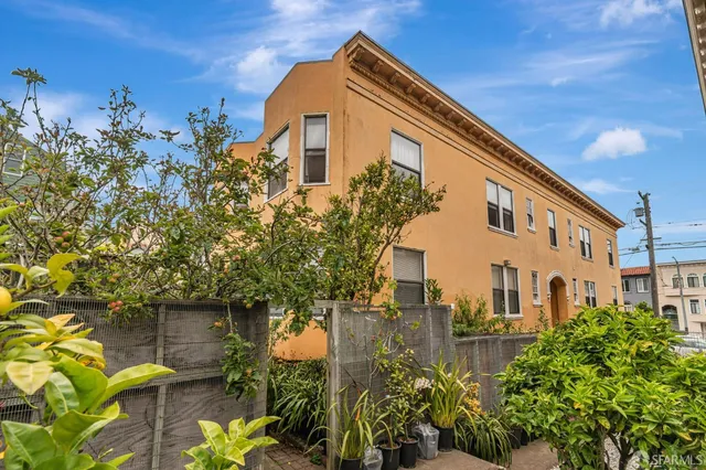 a view of a pathway of a building with potted plants