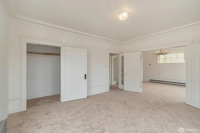 an empty room with windows and closet