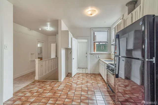 a kitchen with a refrigerator stove and sink