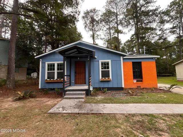 a front view of a house with garden
