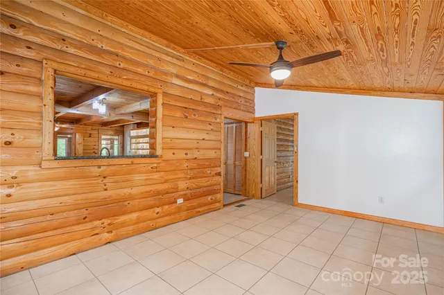 a view of a house with a big yard and large trees