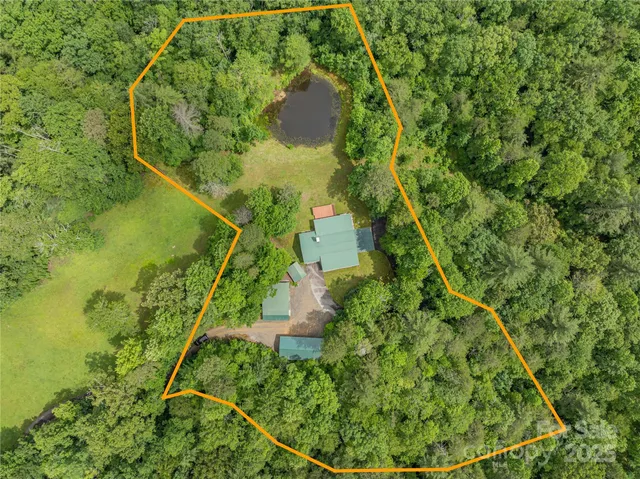 a view of a house with a yard and trees