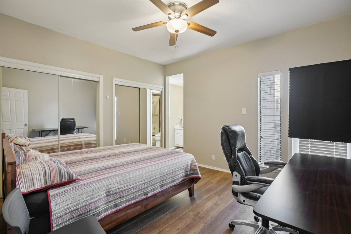 807 West 25th Street, Unit 302 Austin, TX 78705 - Photo 10 of 18 Bedroom with wood-type flooring, a desk, ceiling fan, and ensuite bath