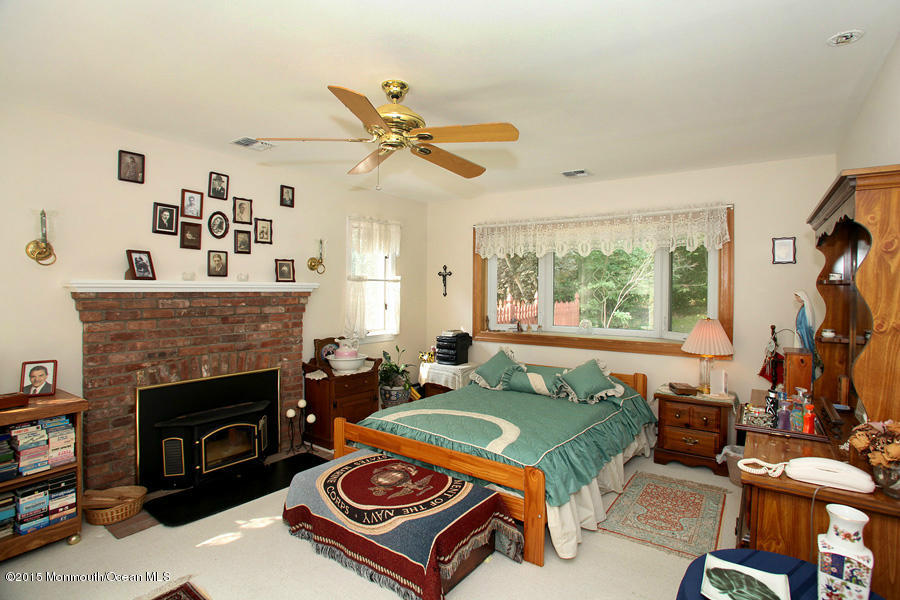 300 Merrick Road Farmingdale, NJ 07727 - Photo 11 of 27 a living room with a couch a fireplace and a large window