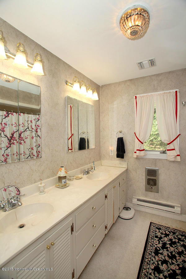300 Merrick Road Farmingdale, NJ 07727 - Photo 12 of 27 a bathroom with a sink and a mirror