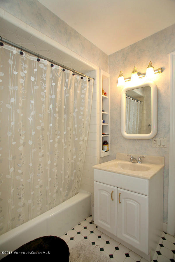 300 Merrick Road Farmingdale, NJ 07727 - Photo 14 of 27 a bathroom with a sink a toilet and shower