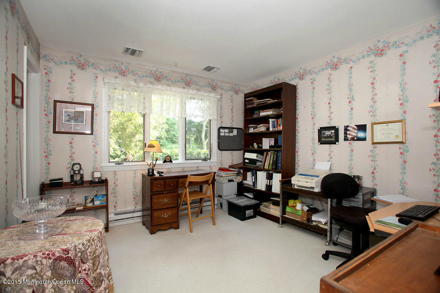 300 Merrick Road Farmingdale, NJ 07727 - Photo 15 of 27 a room with furniture and a window