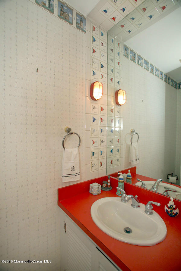 300 Merrick Road Farmingdale, NJ 07727 - Photo 17 of 27 a bathroom with a sink and a mirror