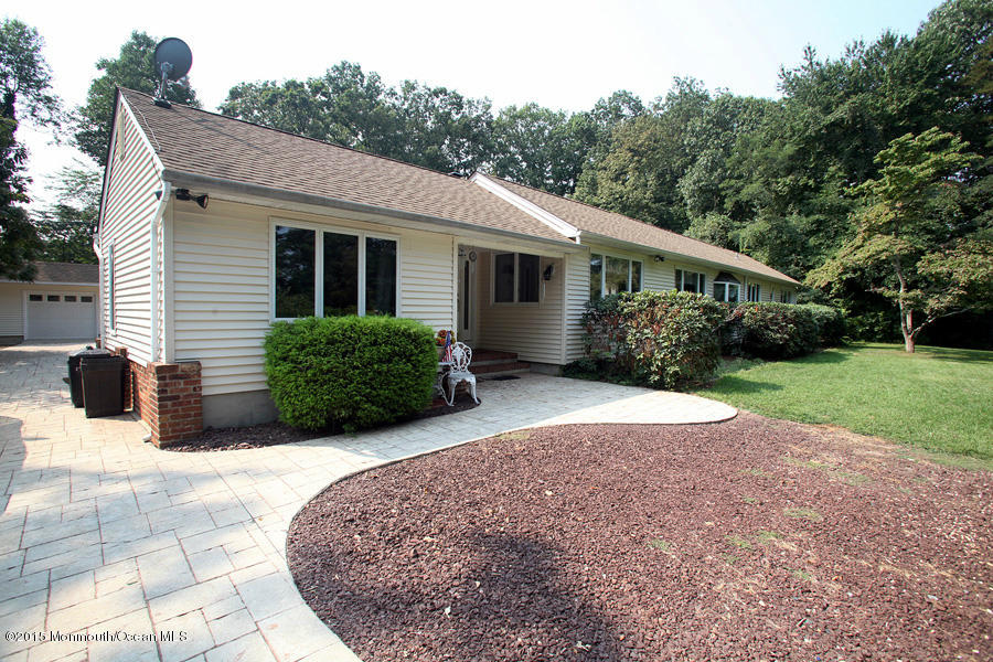 300 Merrick Road Farmingdale, NJ 07727 - Photo 21 of 27 a view of backyard with potted plants and a large tree