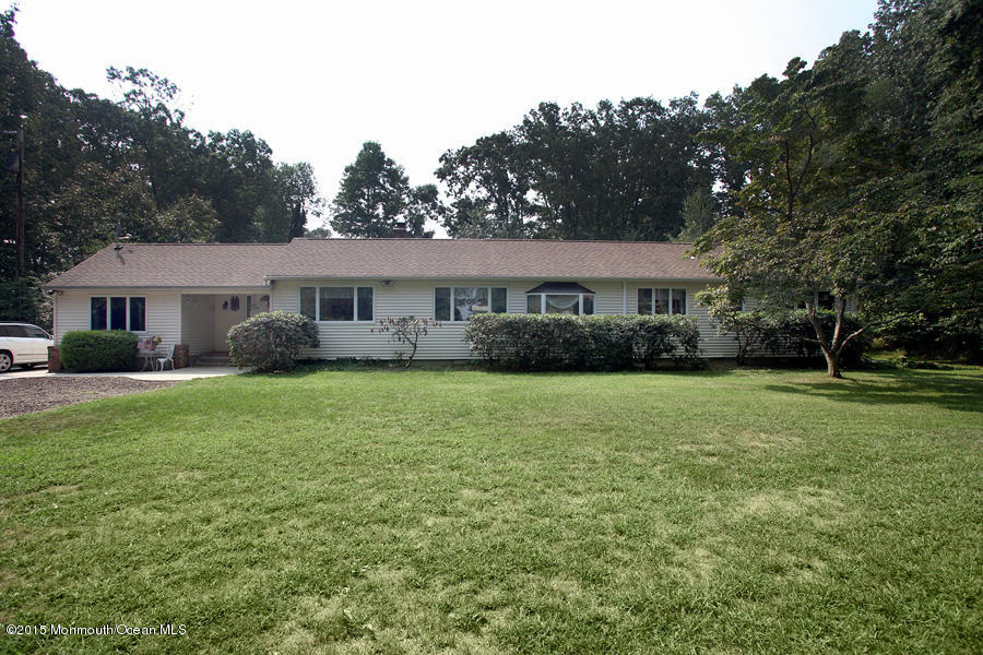 300 Merrick Road Farmingdale, NJ 07727 - Photo 26 of 27 a front view of a house with a yard and trees
