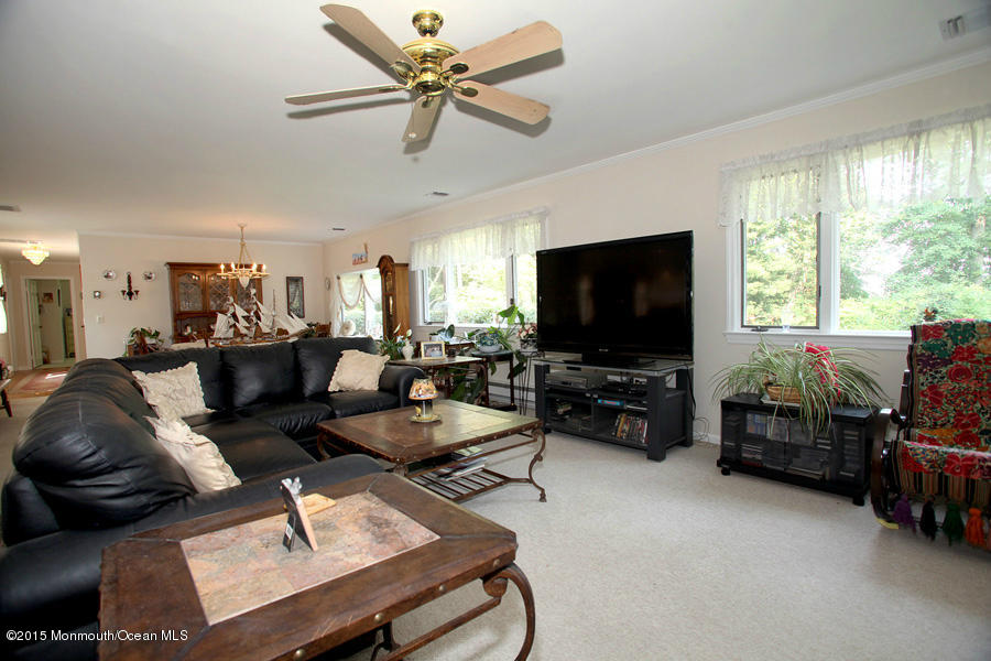 300 Merrick Road Farmingdale, NJ 07727 - Photo 4 of 27 a living room with furniture and a flat screen tv