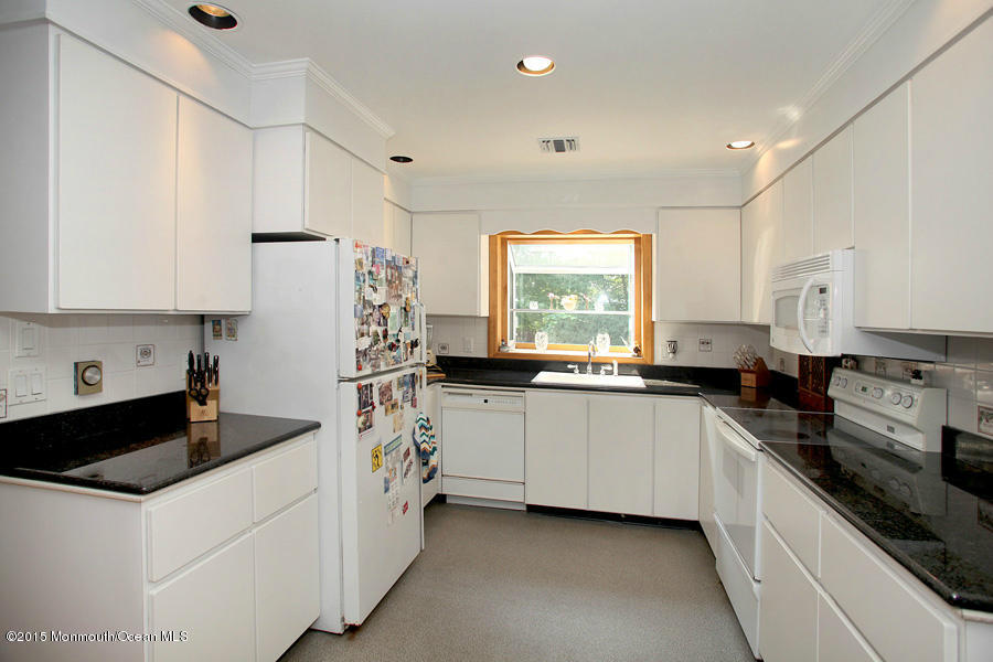300 Merrick Road Farmingdale, NJ 07727 - Photo 5 of 27 a kitchen with a sink a stove and cabinets