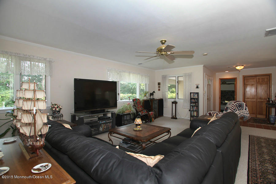 300 Merrick Road Farmingdale, NJ 07727 - Photo 9 of 27 a living room with furniture and a flat screen tv