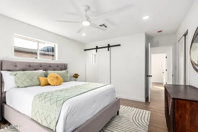 a bedroom with a bed and wooden floor