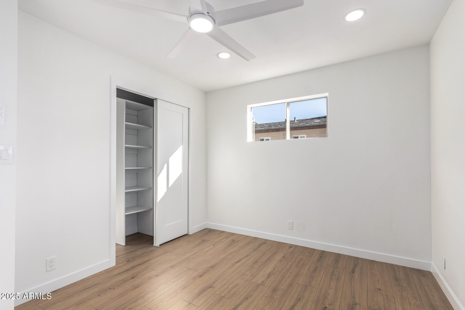 5237 East Dallas Street Mesa, AZ 85205 - Photo 16 of 30 an empty room with wooden floor and window