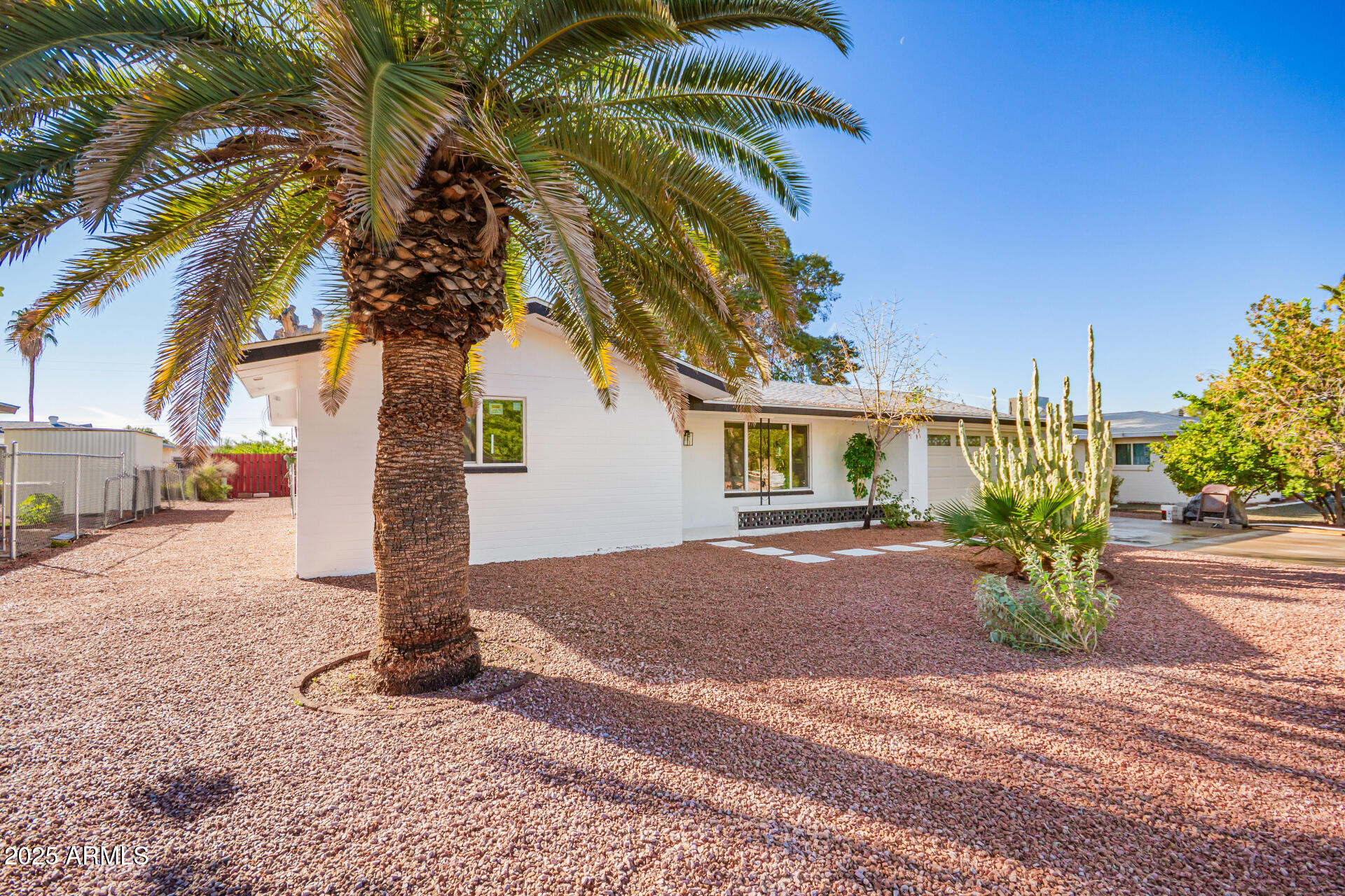 5237 East Dallas Street Mesa, AZ 85205 - Photo 2 of 30 a front view of a house with a yard and garage