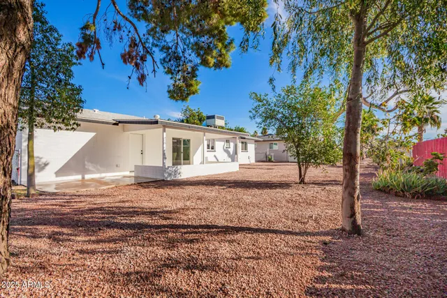 a view of a house with a tree in the background