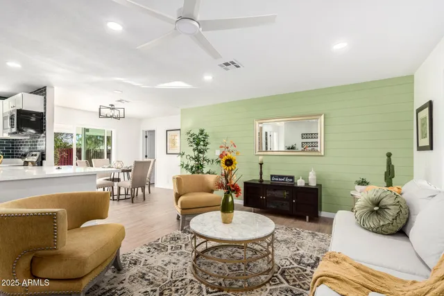 a bedroom with furniture and a large window