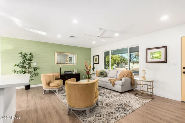 a living room with furniture and wooden floor