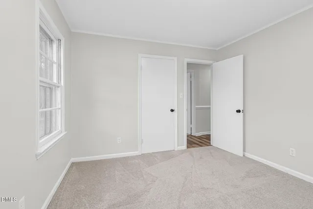 a view of an empty room with a window