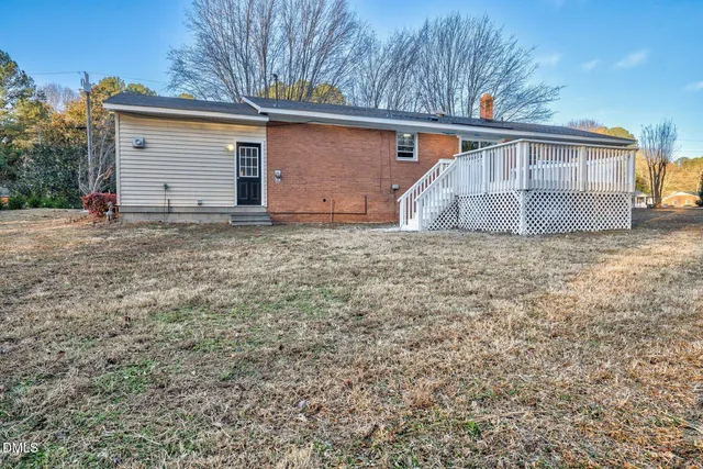 a view of front door and a yard
