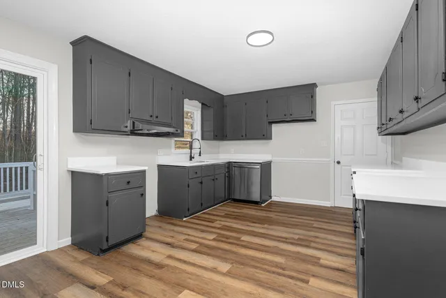 a kitchen with a sink cabinets and a window