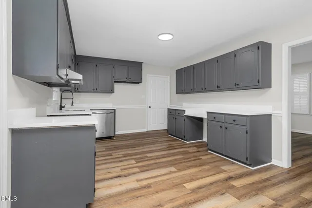 a kitchen with stainless steel appliances cabinets a sink and a stove