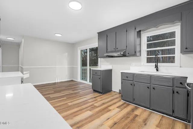 a kitchen with a sink cabinets and window