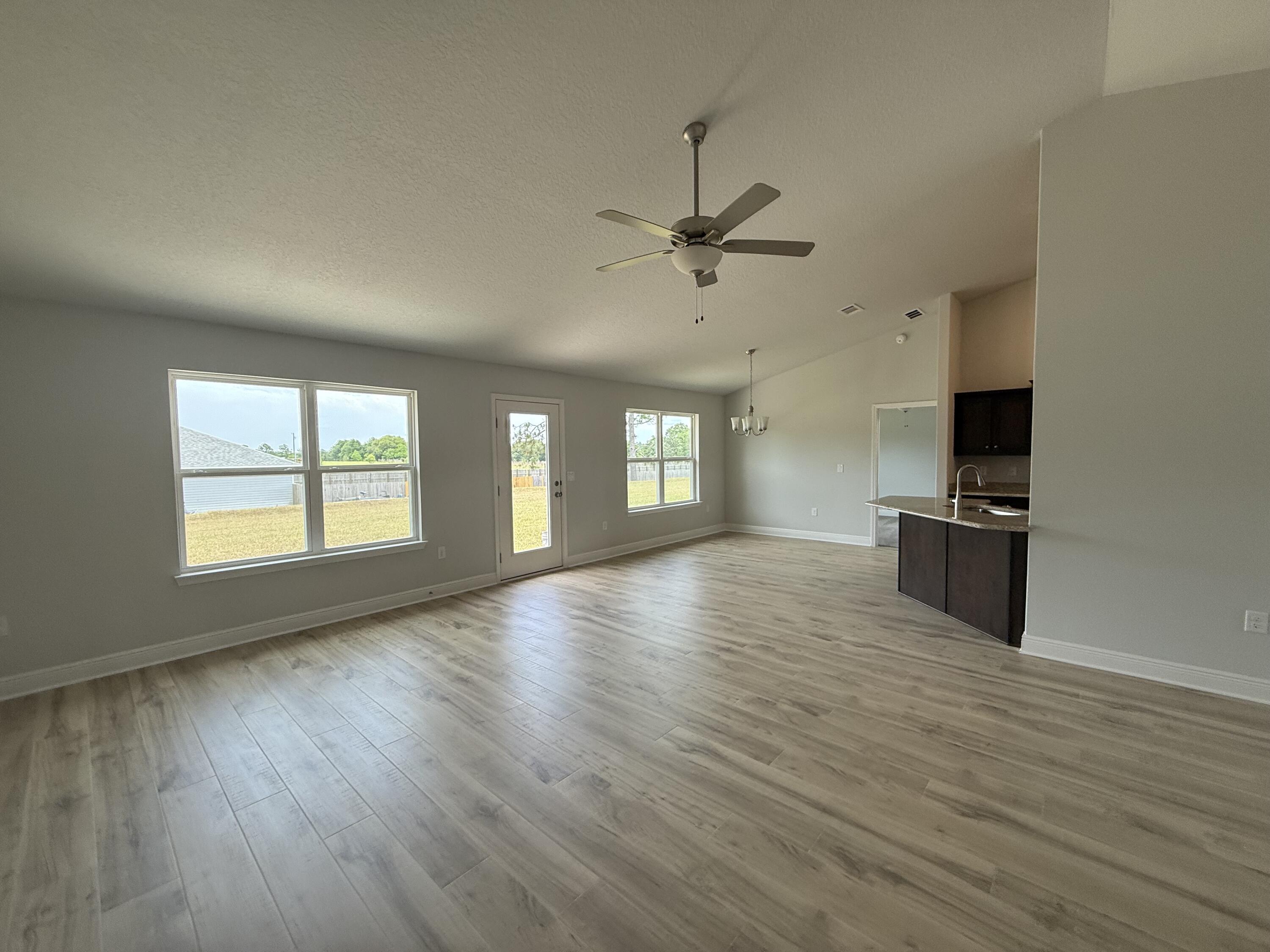6000 Crocket Cove Crestview, FL 32539 - Photo 8 of 20 a view of a kitchen with wooden floor and a window