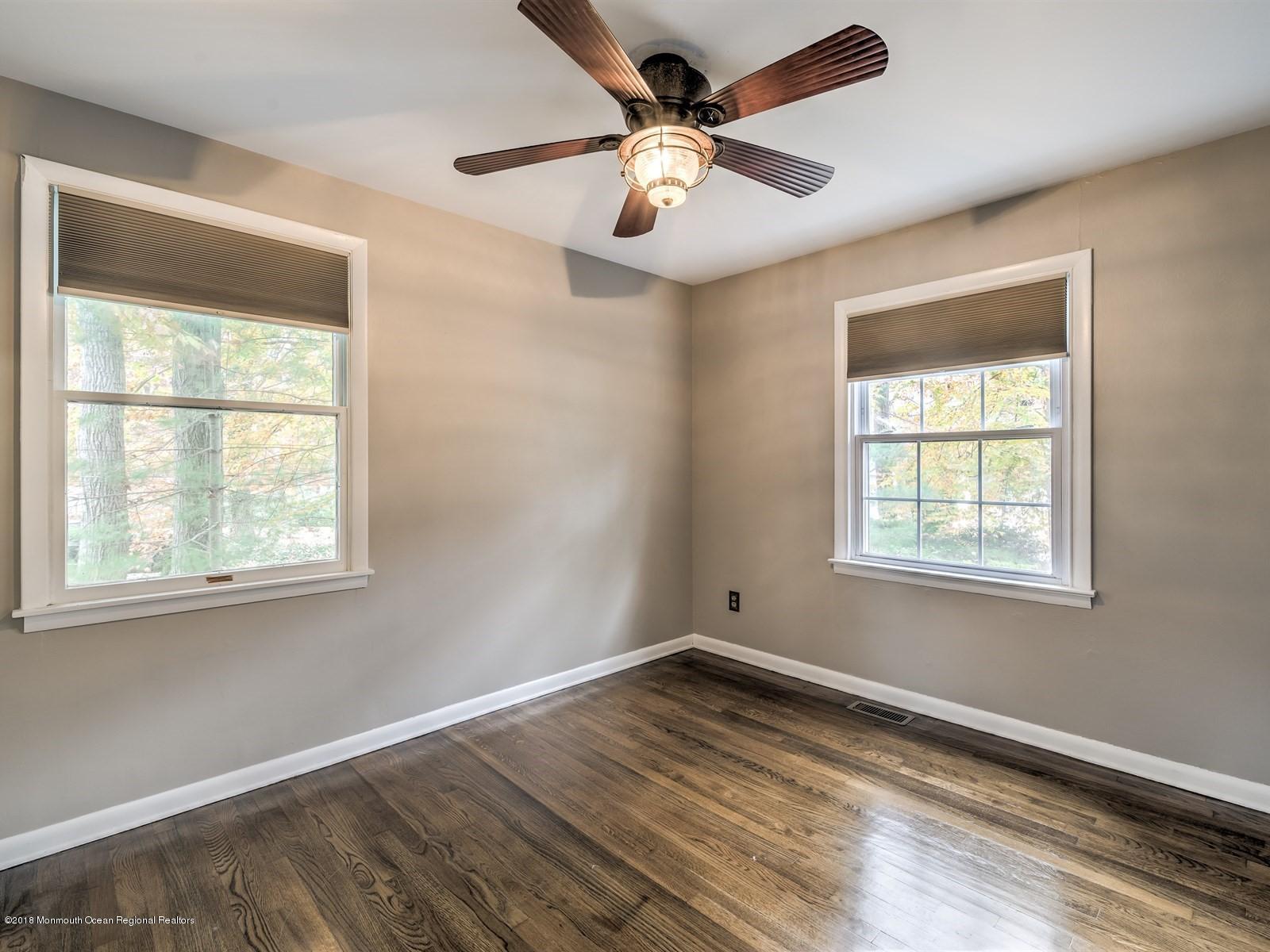 65 Streeker Road Wrightstown, NJ 08562 - Photo 22 of 34 a view of an empty room with wooden floor and a window