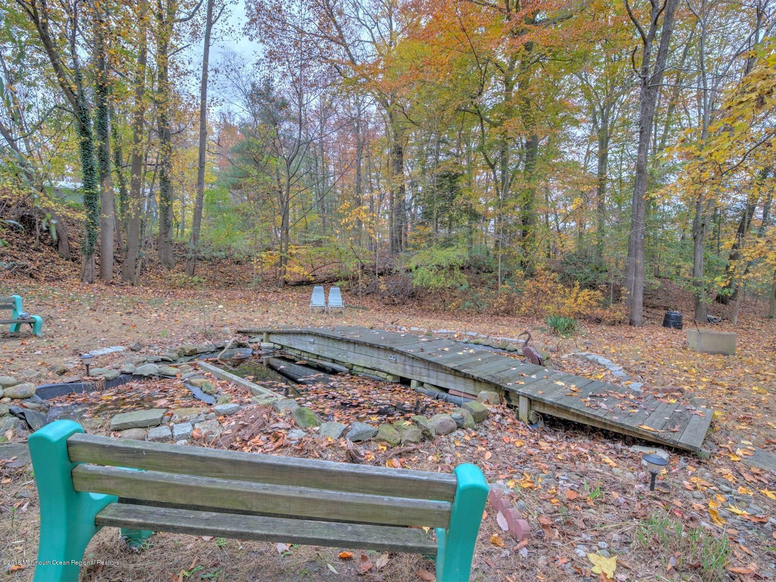 65 Streeker Road Wrightstown, NJ 08562 - Photo 26 of 34 a view of a backyard with wooden fence and trees