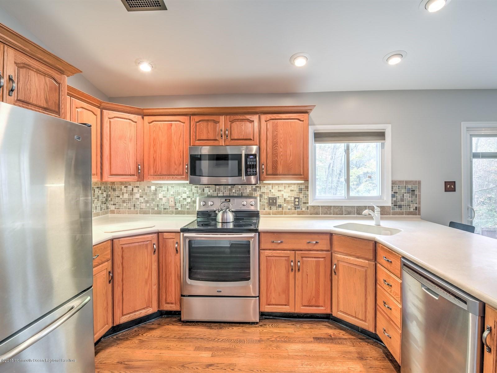 65 Streeker Road Wrightstown, NJ 08562 - Photo 3 of 34 a kitchen with stainless steel appliances granite countertop a refrigerator sink and cabinets