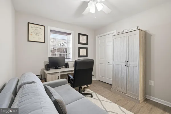a view of a livingroom with workspace and a window