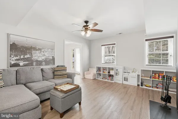 a living room with furniture and a large window with wooden floor