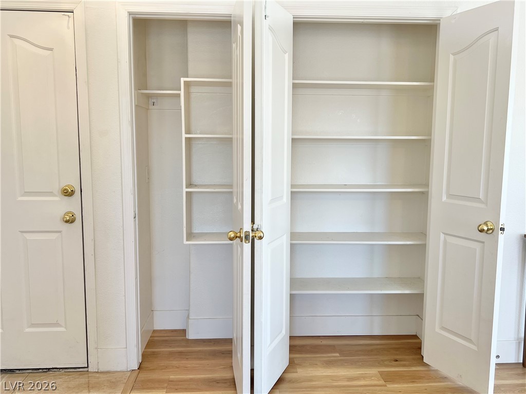 9708 Ridge Creek Place Las Vegas, NV 89134 - Photo 14 of 34 Functional built-in shelving offers ample storage, enhancing home organization.