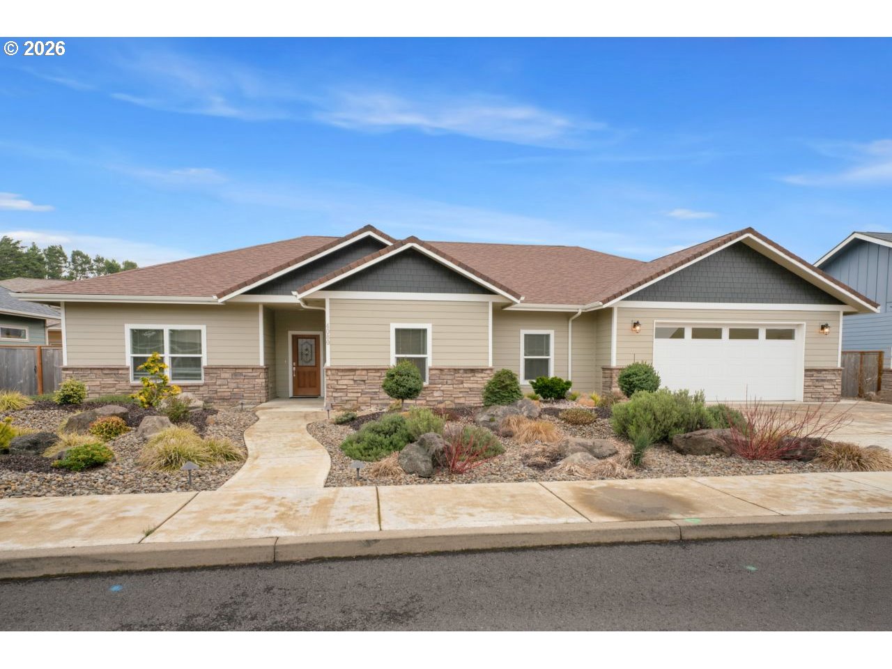 4080 Caddington Lane Florence, OR 97439 - Photo 1 of 48 a front view of a house with garden
