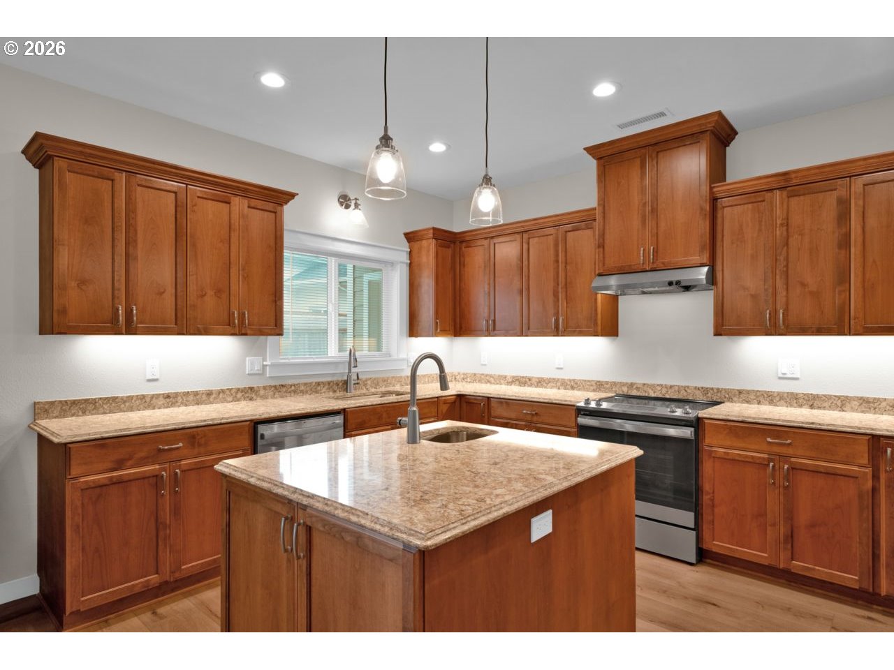 4080 Caddington Lane Florence, OR 97439 - Photo 15 of 48 a kitchen with a sink a stove a refrigerator and wooden cabinets