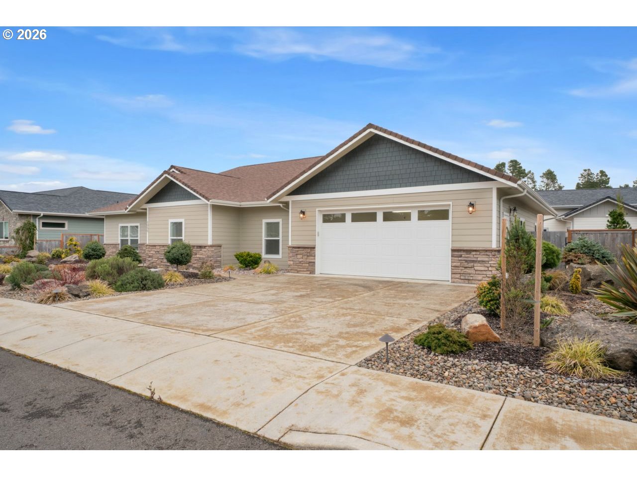 4080 Caddington Lane Florence, OR 97439 - Photo 3 of 48 a front view of a house with a yard and garage