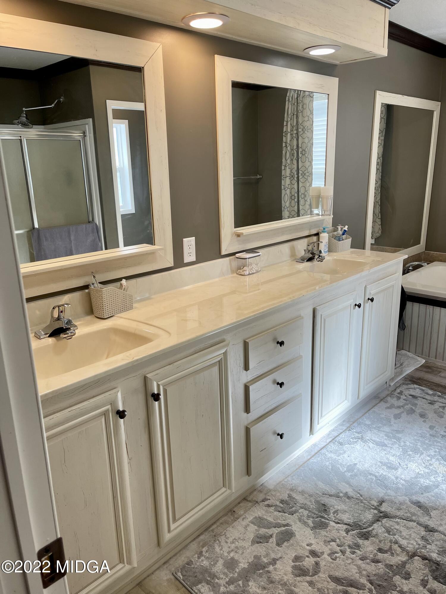 9532 Old Gordon Road Dry Branch, GA 31020 - Photo 11 of 29 a bathroom with a granite countertop sink and a mirror