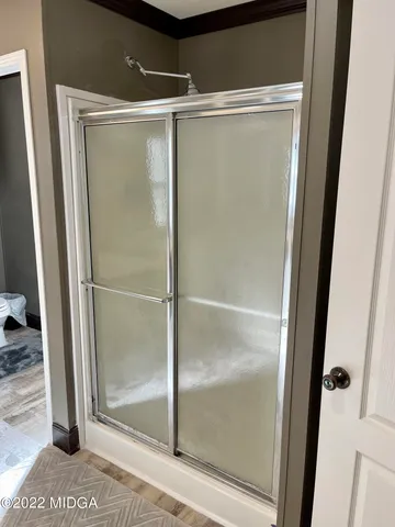 a bathroom with a glass shower door