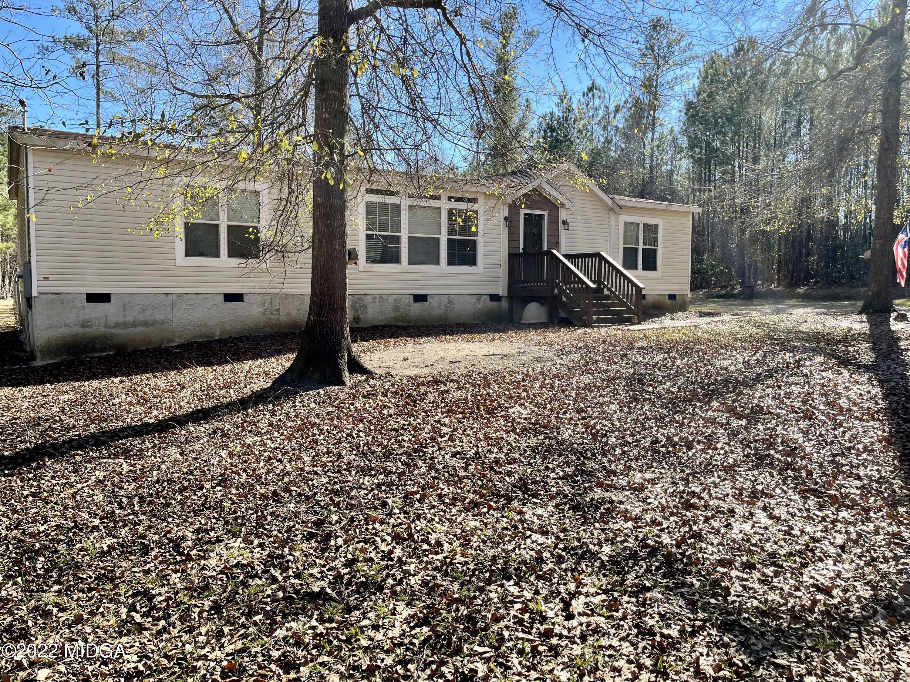 9532 Old Gordon Road Dry Branch, GA 31020 - Photo 19 of 29 a front view of a house with a yard