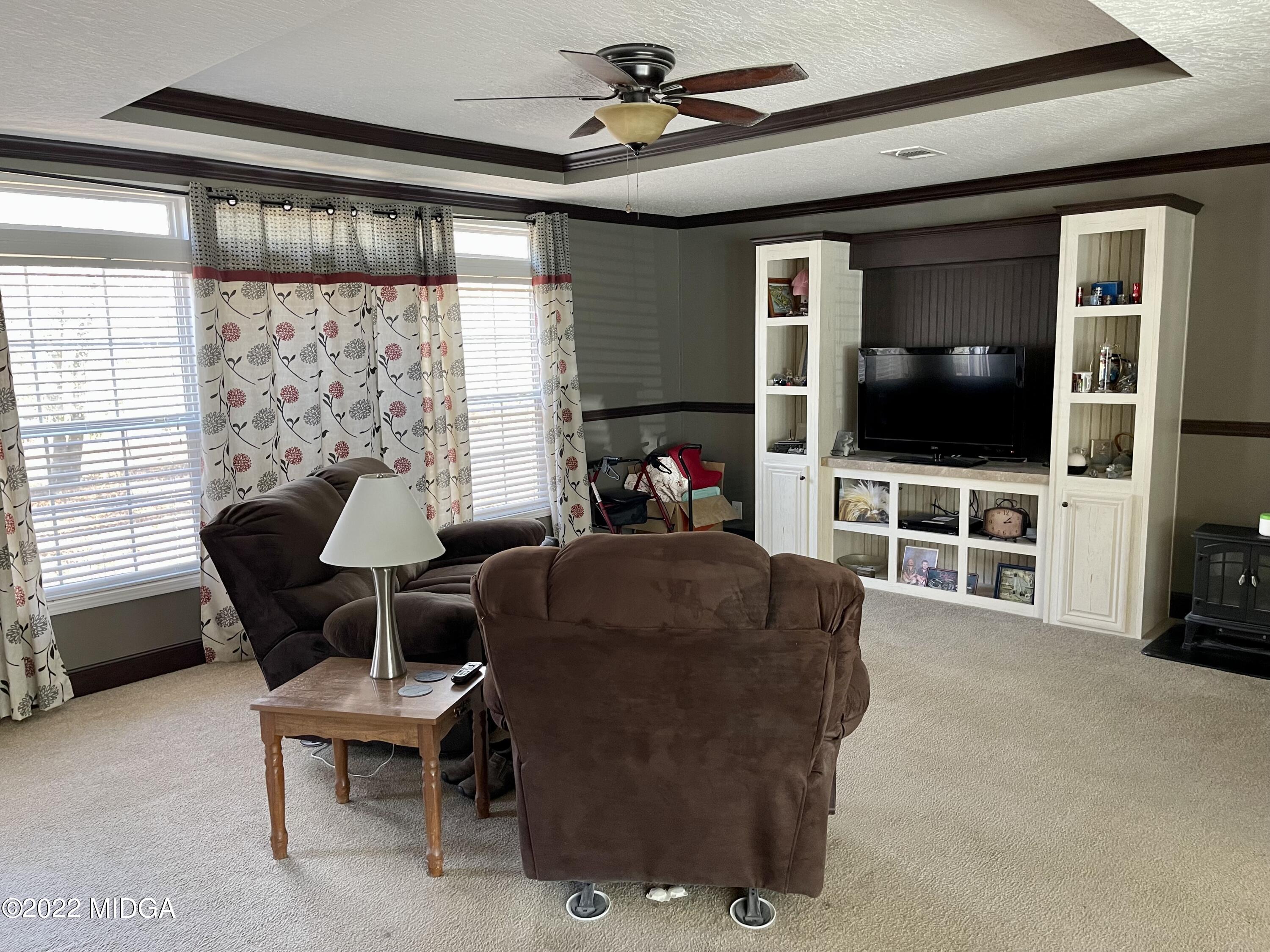 9532 Old Gordon Road Dry Branch, GA 31020 - Photo 3 of 29 a living room with furniture and a flat screen tv