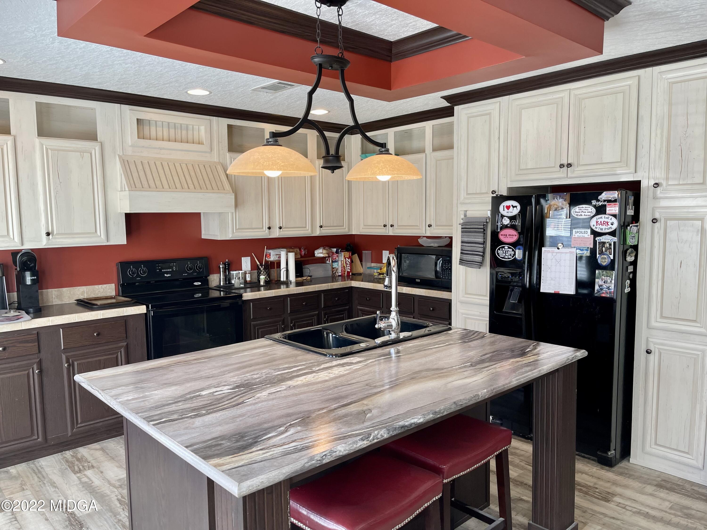 9532 Old Gordon Road Dry Branch, GA 31020 - Photo 5 of 29 a kitchen with stainless steel appliances granite countertop a sink a stove and refrigerator