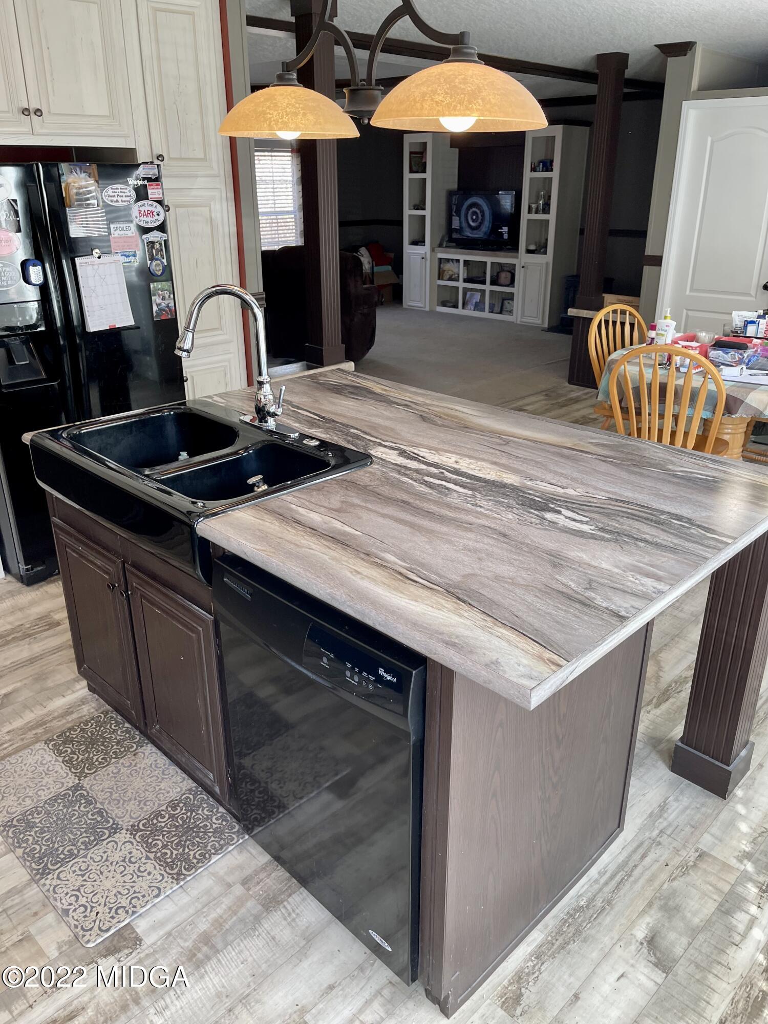 9532 Old Gordon Road Dry Branch, GA 31020 - Photo 6 of 29 a kitchen with stainless steel appliances granite countertop a sink and a stove